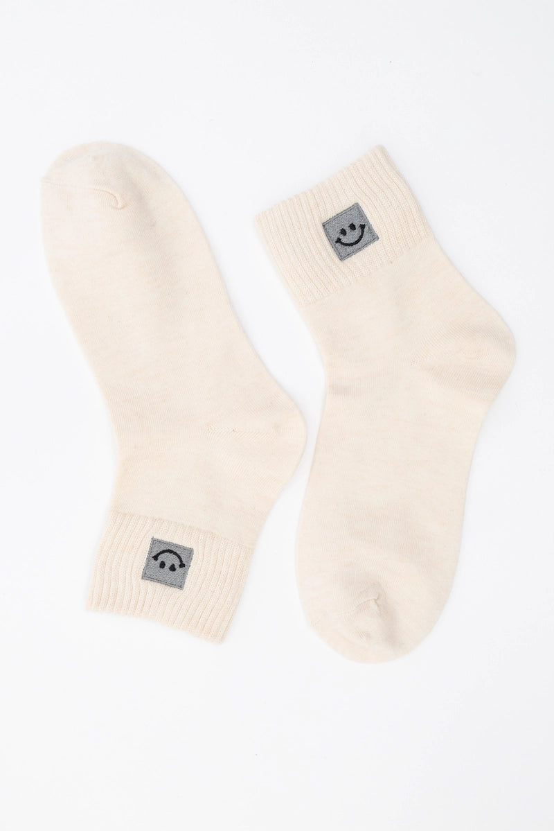 SNOWED IN smiley-face socks